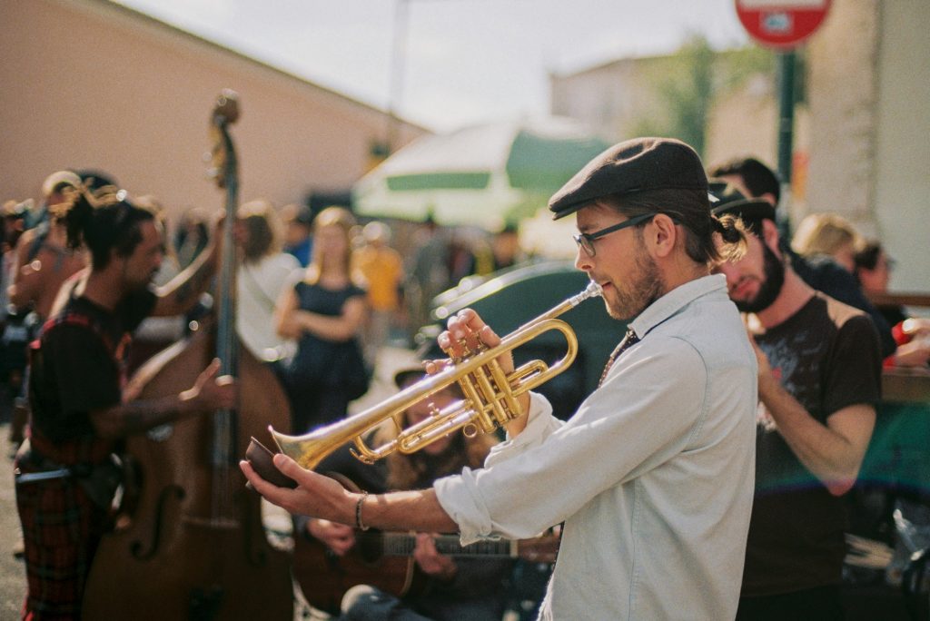 A brass player with a street band