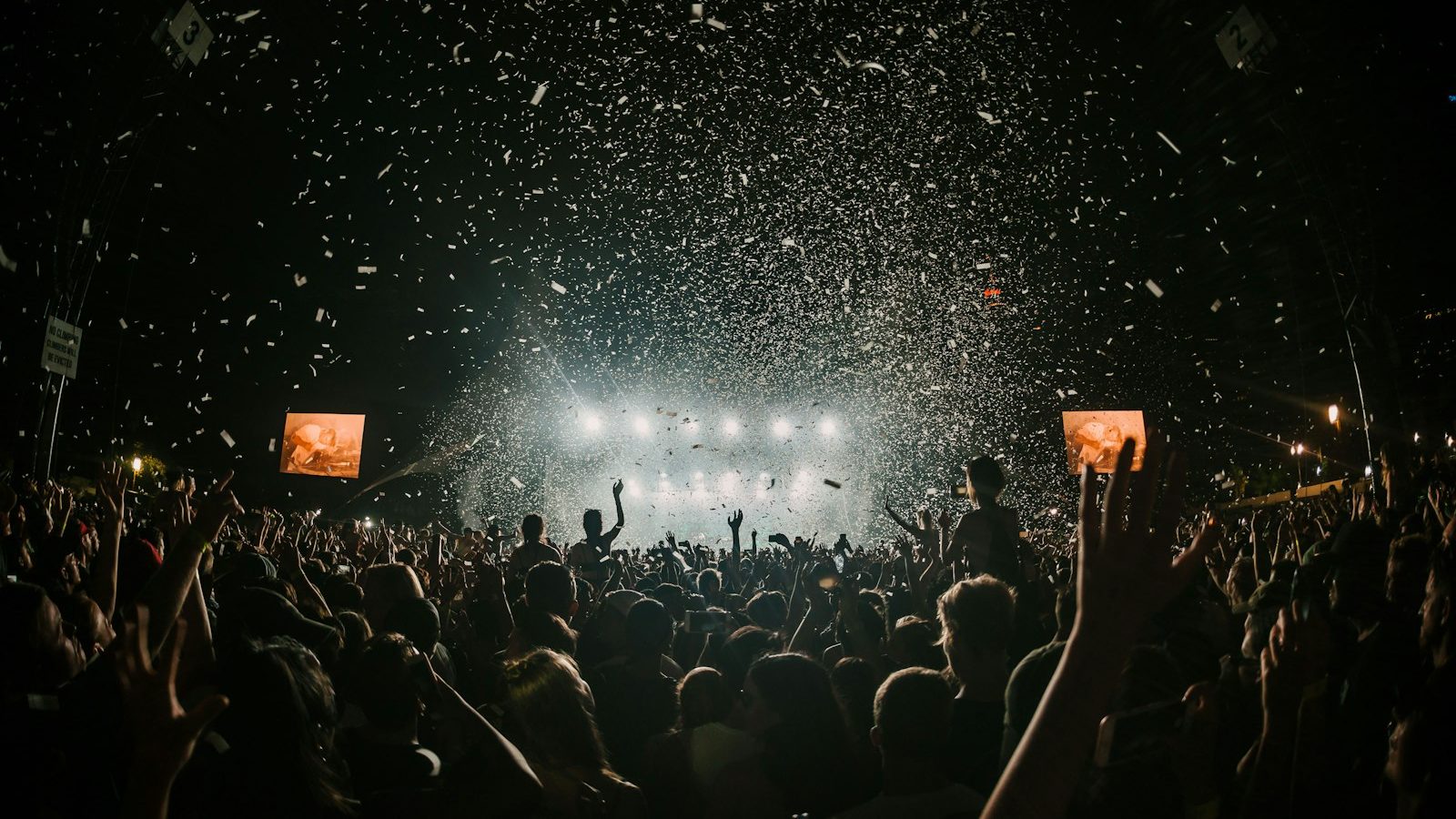 A band on stage in front of a full room