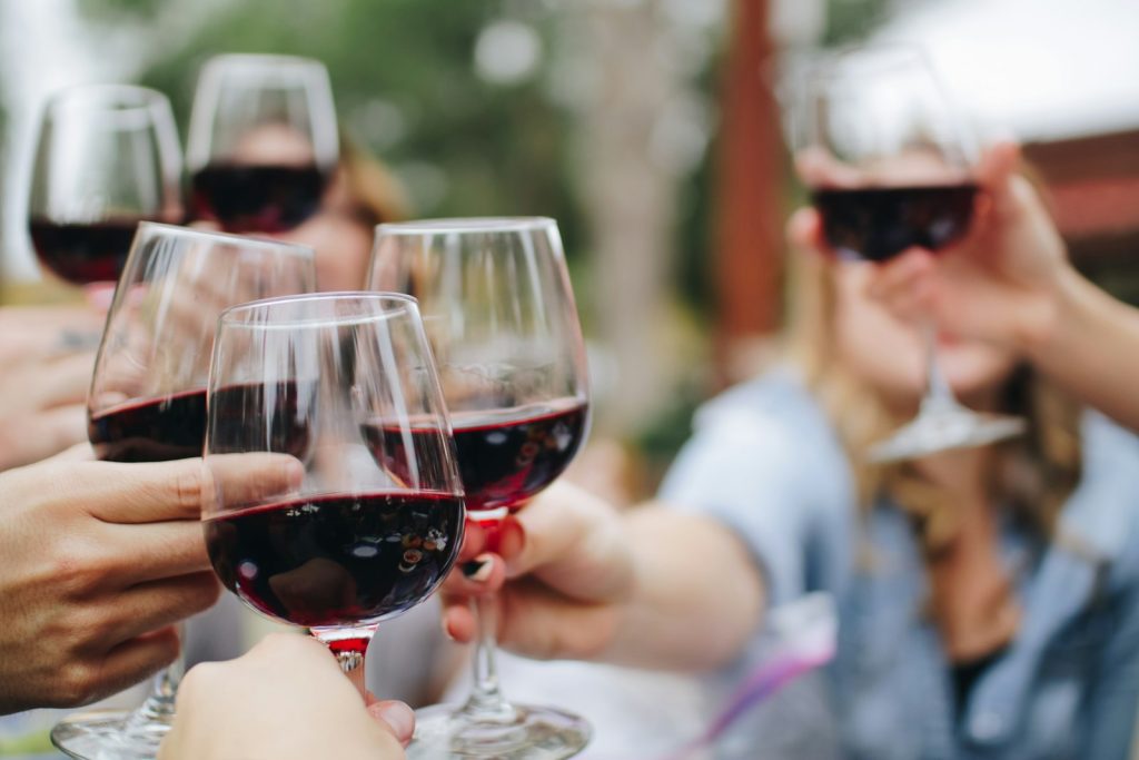 Glasses of wine raised around a table